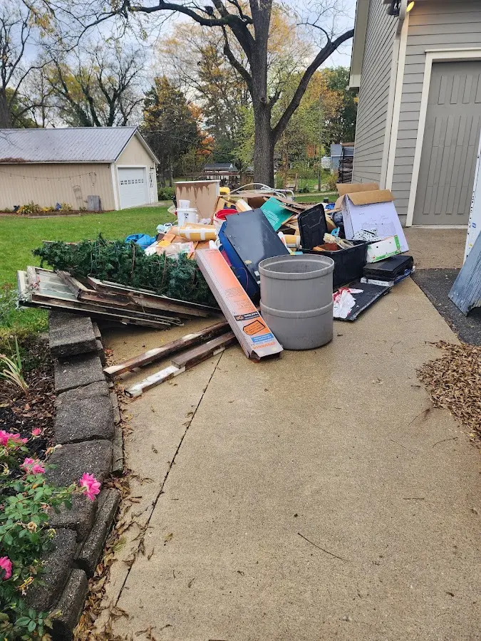 Dumpster being loaded with debris for Roofing Dumpster Rental in Faribault